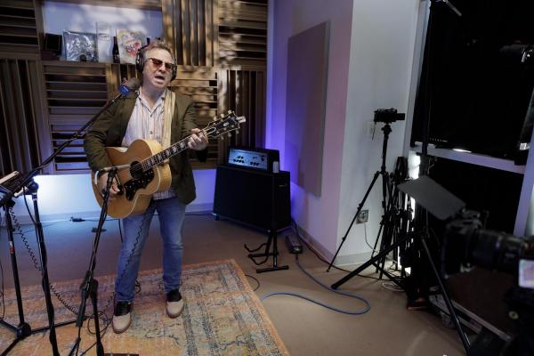 WIDE SHOT OF GRANT LEE PHILLIPS IN STUDIO