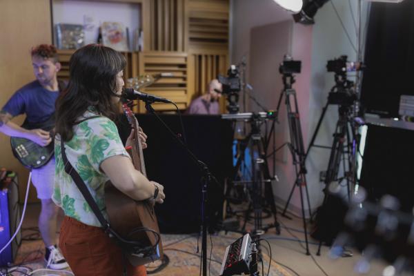 Wide Shot of The Beths looking from behind showing the cameras in the studio